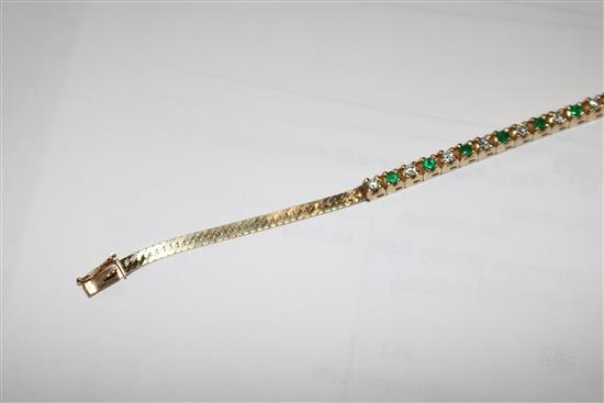 A 14ct gold, emerald and diamond small line bracelet, 15cm.